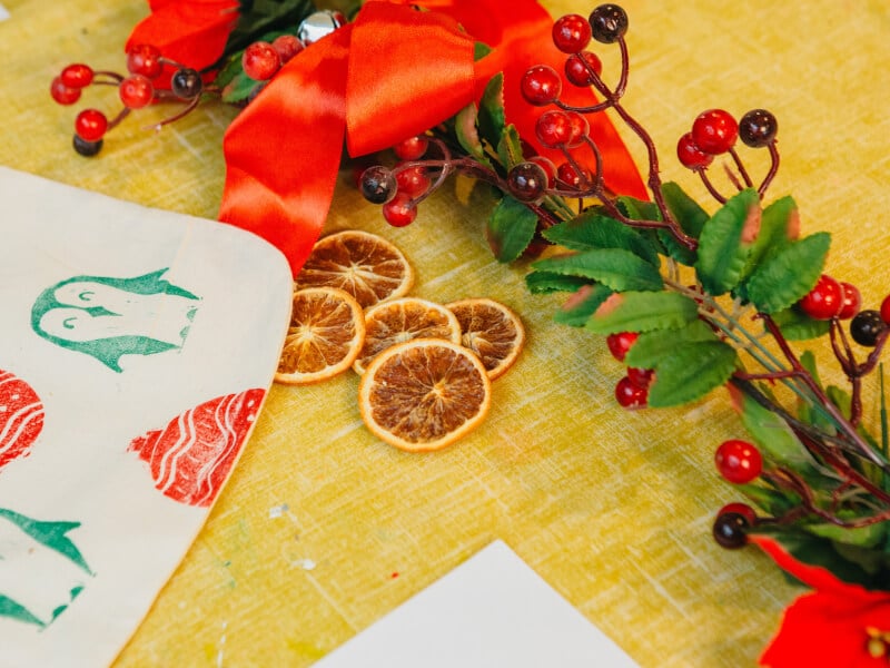 Christmas crafts laid out on a yellow table